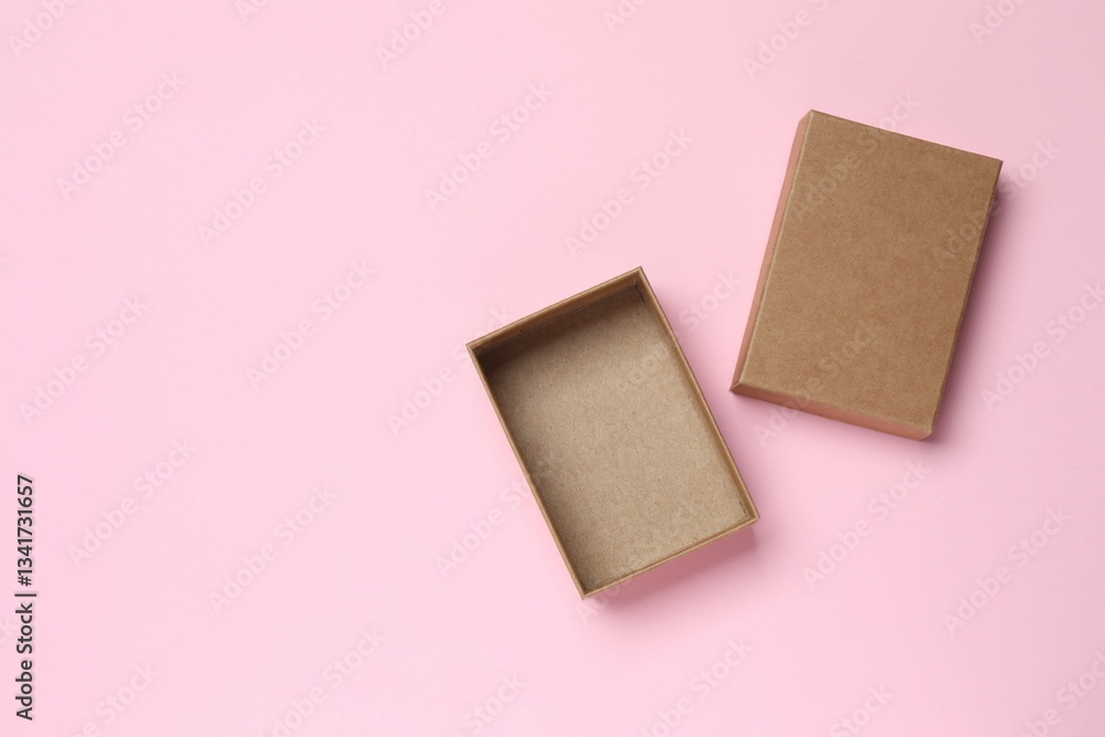 Open cardboard box on pink background Open cardboard box on pink background