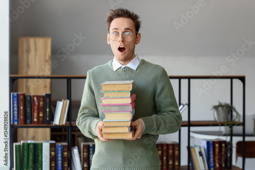 Young man with stack of boo...
