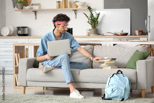 Male student studying with ...