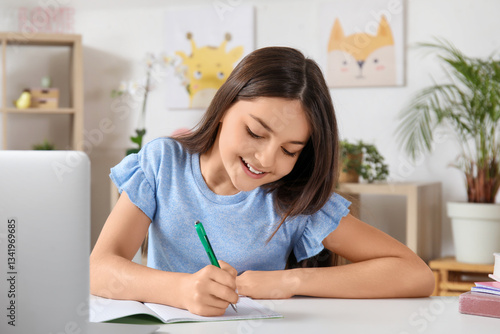 Little girl doing lessons a...