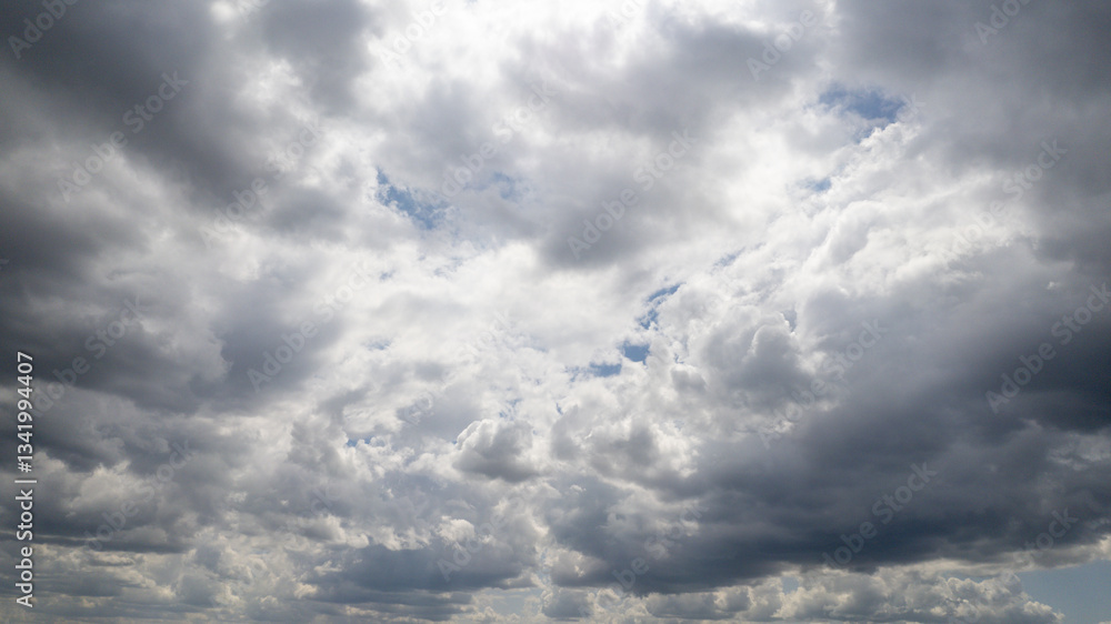 Fluffy gray clouds blanket the sky, foreboding stormy weather, atmospheric mood, nature's canvas background Fluffy gray clouds blanket the sky, foreboding stormy weather, atmospheric mood, nature's canvas background