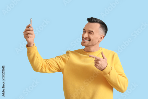 Happy young man with mobile...