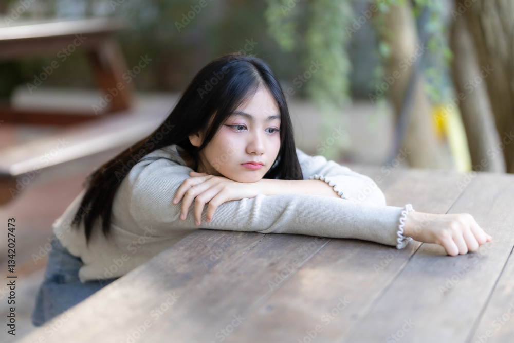 Portrait cute smiles Asian girl putting her hands on table of attractive young teenage girl the cafe on vacation at a coffee shop in spring day