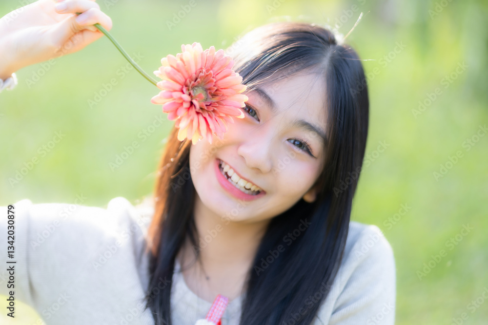 Portrait cute smiles Asian of attractive young teenage girl Holding flowers the cafe on vacation at a coffee shop in spring day