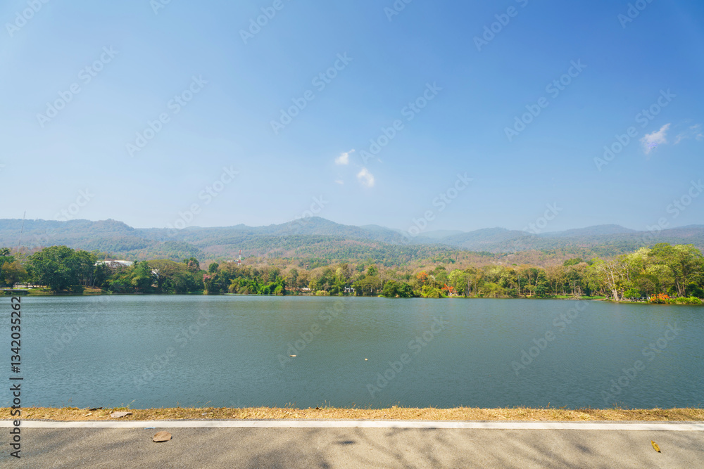 a public place leisure travel landscape lake views at Ang Kaew Chiang Mai University and Doi Suthep nature forest Mountain views spring cloudy sky background with white cloud.