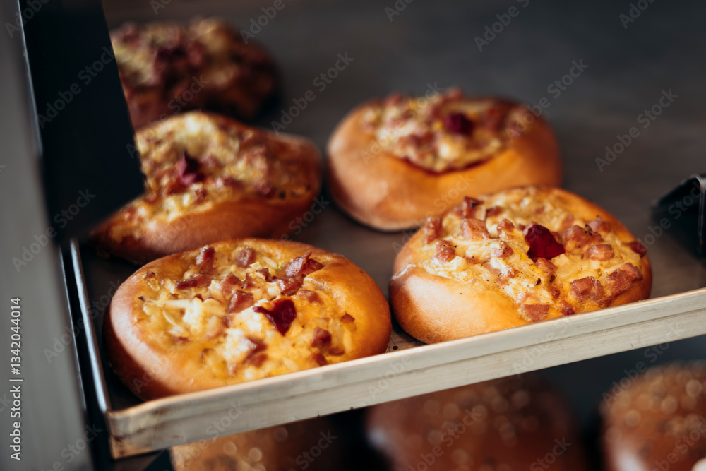 Mini pizzas at the bakery, freshly baked savory buns. Mini pizzas at the bakery, freshly baked savory buns.