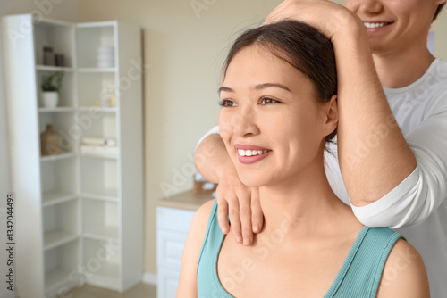 Young Asian woman getting m...