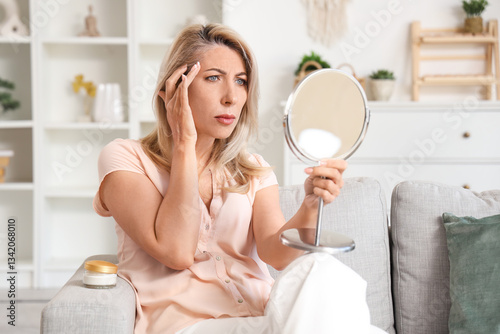 Sad mature woman looking in...