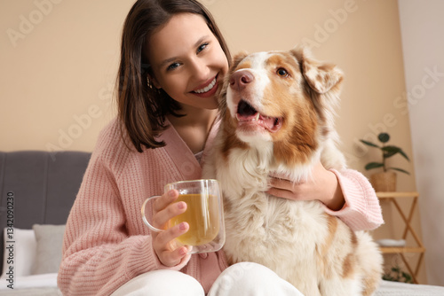 Happy young woman with cup ...