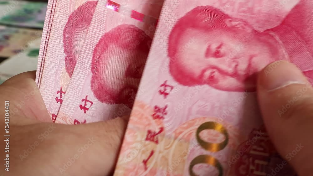 Macro shot of man's hands and Chinese Yuan (CNY) banknotes. Concept of saving money for retirement, cash settlement, financial success, literacy and income planning in China. Close up view. Macro shot of man's hands and Chinese Yuan (CNY) banknotes. Concept of saving money for retirement, cash settlement, financial success, literacy and income planning in China. Close up view.
