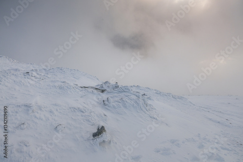 Obraz na płótnie Babia Góra at sunset, covered in winter snow. A stunning mountain landscape in Babia Góra National Park, Poland. Golden light contrasts with icy peaks, creating a breathtaking view for nature and trav w salonie