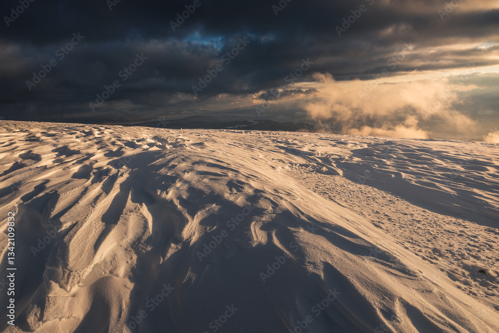 Babia Góra at sunset, covered in winter snow. A stunning mountain landscape in Babia Góra National Park, Poland. Golden light contrasts with icy peaks, creating a breathtaking view for nature and trav
