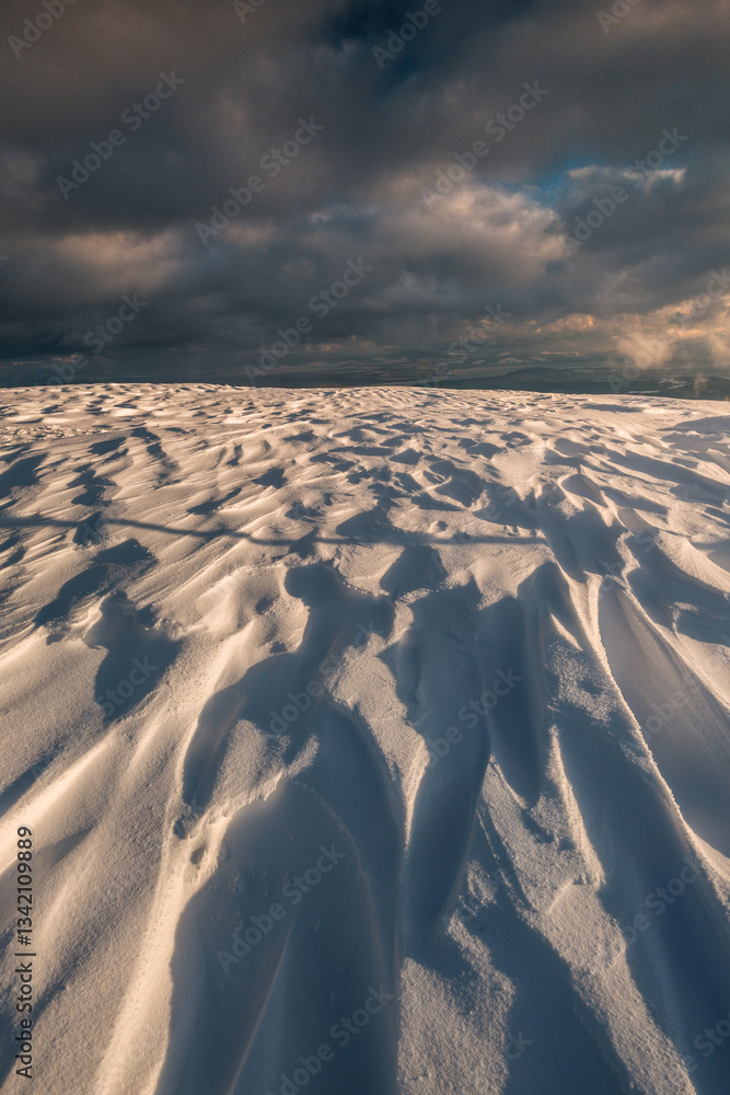 Babia Góra at sunset, covered in winter snow. A stunning mountain landscape in Babia Góra National Park, Poland. Golden light contrasts with icy peaks, creating a breathtaking view for nature and trav