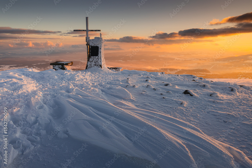 Babia Góra at sunset, covered in winter snow. A stunning mountain landscape in Babia Góra National Park, Poland. Golden light contrasts with icy peaks, creating a breathtaking view for nature and trav