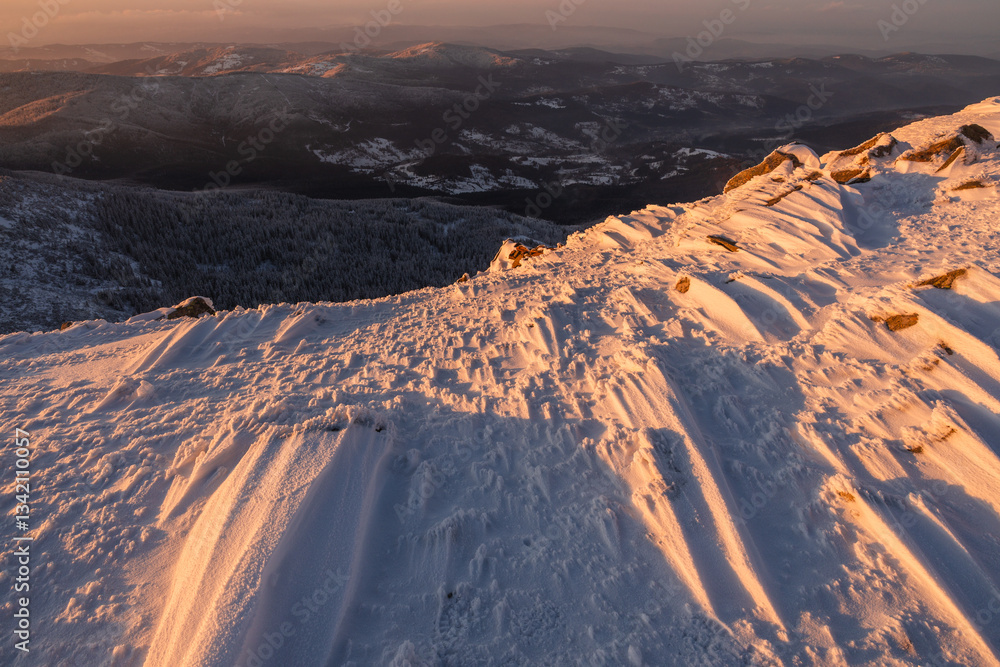 Babia Góra at sunset, covered in winter snow. A stunning mountain landscape in Babia Góra National Park, Poland. Golden light contrasts with icy peaks, creating a breathtaking view for nature and trav