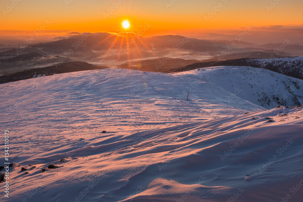 Babia Góra at sunset, covered in winter snow. A stunning mountain landscape in Babia Góra National Park, Poland. Golden light contrasts with icy peaks, creating a breathtaking view for nature and trav