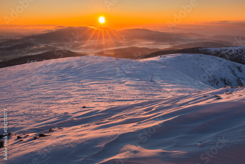 Obraz na płótnie Babia Góra at sunset, covered in winter snow. A stunning mountain landscape in Babia Góra National Park, Poland. Golden light contrasts with icy peaks, creating a breathtaking view for nature and trav w salonie