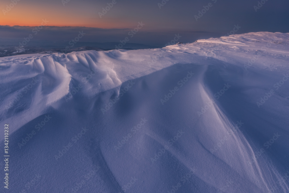 Babia Góra at sunset, covered in winter snow. A stunning mountain landscape in Babia Góra National Park, Poland. Golden light contrasts with icy peaks, creating a breathtaking view for nature and trav