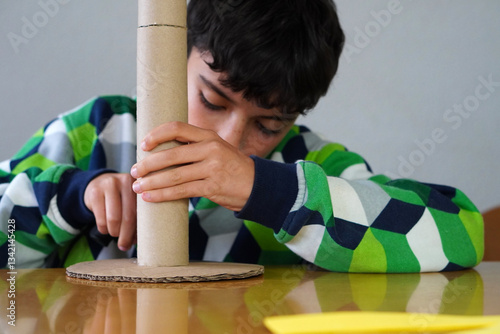 Принти на полотні child making handicrafts building a structure with cardboard