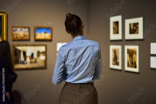 visitor in historical museum looking at art object