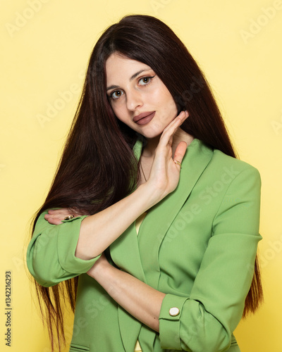 Obraz na płótnie Fashion portrait of beautiful model in green suit against yellow background w salonie