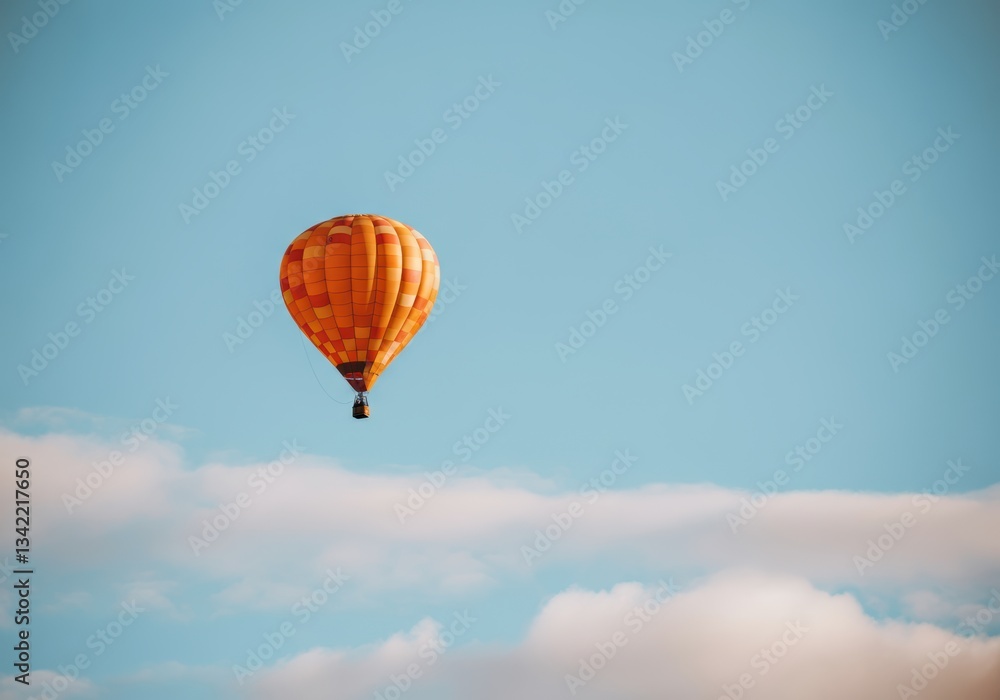 Obraz premium Colorful hot air balloon soaring in a clear blue sky