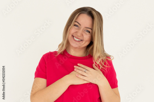 Wallpaper Mural Smiling woman holding hands on chest. Isolated portrait. Torontodigital.ca