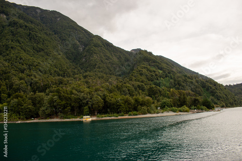 Scenic views of a lake surrounded by lush forests and rolling hills. Nature’s beauty unfolds with towering trees, serene waters, and distant mountains, creating a peaceful and pristine landscape