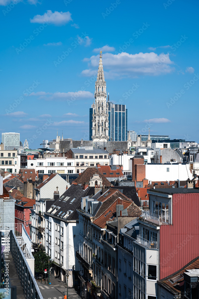 Fototapeta premium Town hall gothical tower and contemporary finance tower in the background, high angle view of Brussels old town, Brussels Capital Region, Belgium. March 16, 2025