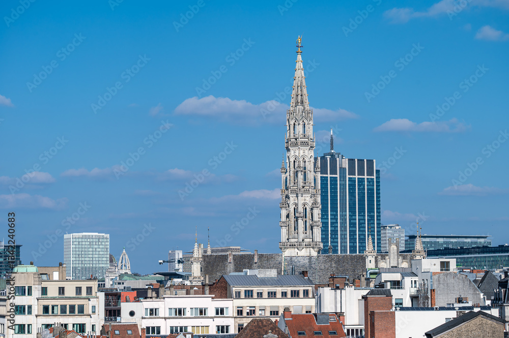 Fototapeta premium Town hall gothical tower and contemporary finance tower in the background, high angle view of Brussels old town, Brussels Capital Region, Belgium. March 16, 2025