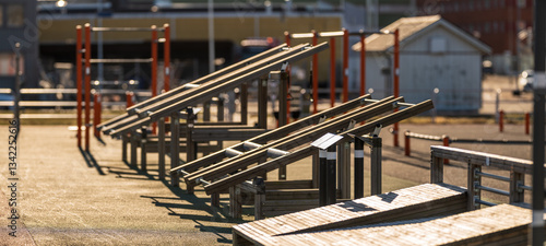 outdoor fitness park with wooden exercise equipment.
