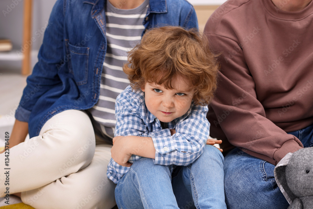 Resentful little boy and his parents arguing at home Resentful little boy and his parents arguing at home