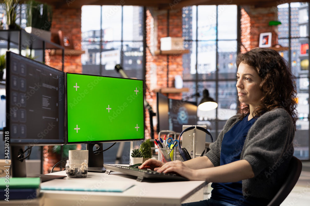 Focused person interacting with a chatbot interface next to chroma key, AI system leverages machine learning and automation to generate helpful responses. Improve online data driven workflow.