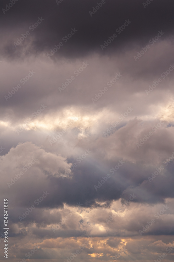 large white thunderclouds with bright rays of sunlight breaking through them large white thunderclouds with bright rays of sunlight breaking through them