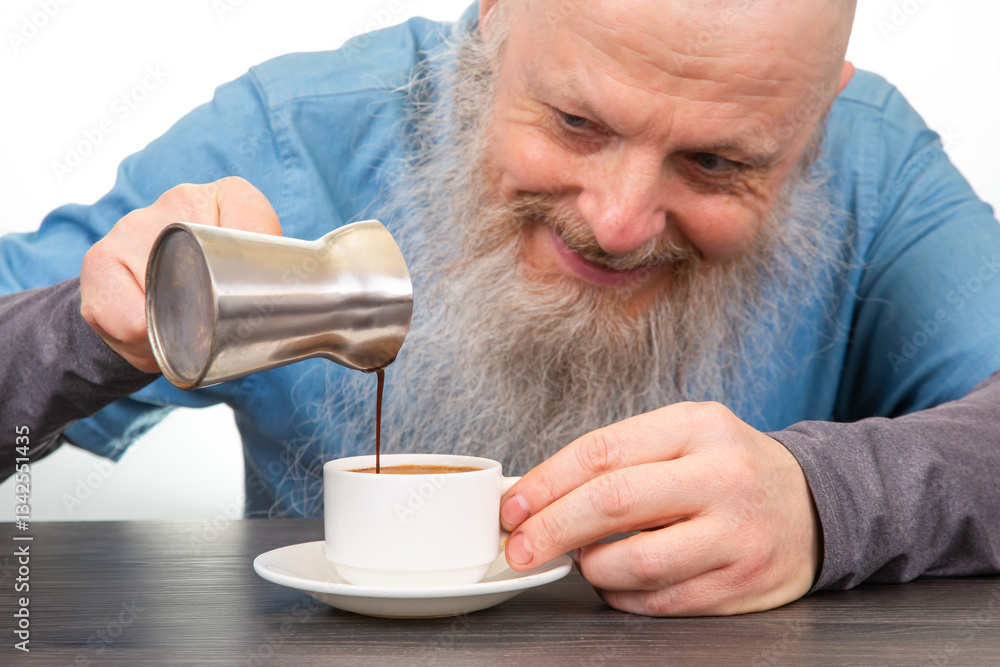 happy man with a long white beard pours coffee from a cezve into a white cup on a rustic table, homemade breakfast atmosphere. hot drink. happy man with a long white beard pours coffee from a cezve into a white cup on a rustic table, homemade breakfast atmosphere. hot drink.