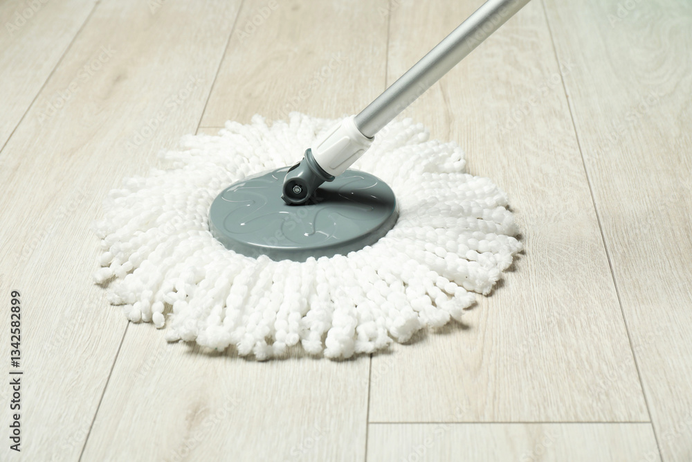 Fototapeta premium String mop on wooden floor. Cleaning equipment