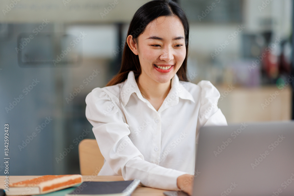 Smiling business asian woman using laptop at work document sitting in the office, Smiling business asian woman using laptop at work document sitting in the office,