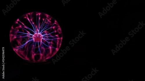 A Plasma Ball Set to the Left With a Black Background