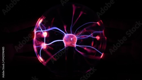 Close Up of a Plasma Globe Lamp With Hands on Both Sides