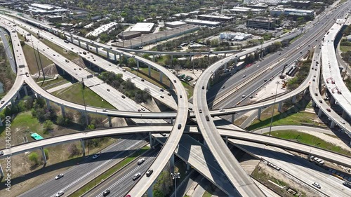 Aerial timelapse of busy highway interchange during middle of afternoon