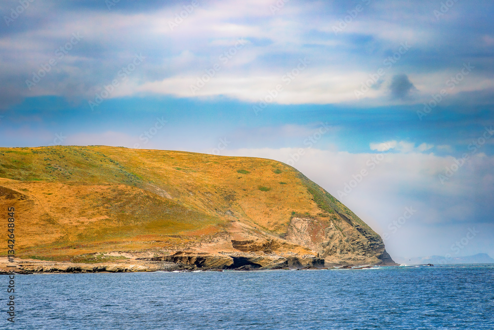 Striking dramatic skies hang over the coastal shores of the Channel Islands during a colorful Springtime day