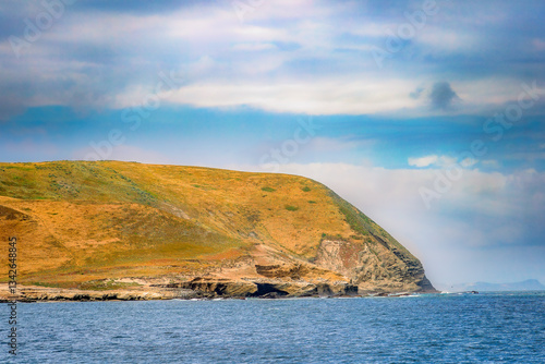 Obraz na płótnie Striking dramatic skies hang over the coastal shores of the Channel Islands during a colorful Springtime day w salonie