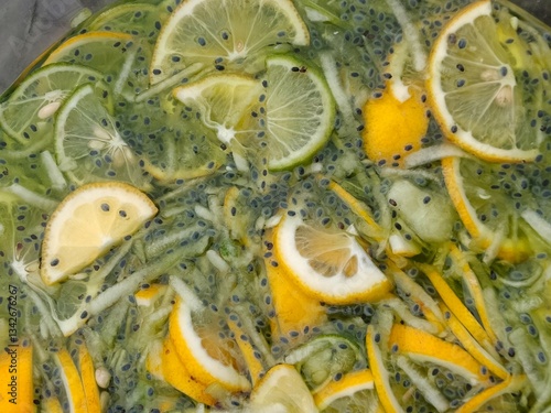 A refreshing drink with orange flavor mixed with slices of lemon, lime, cucumber, and basil seeds floating in cold water. In Indonesia it is usually called 