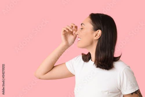 Young woman touching her no...