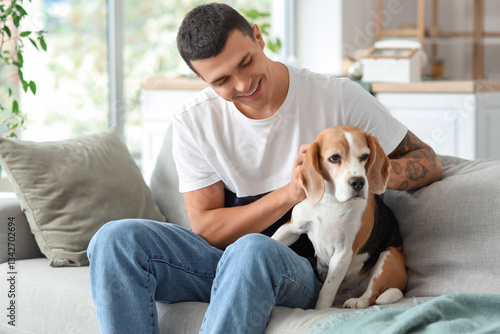 Young man with cute Beagle ...