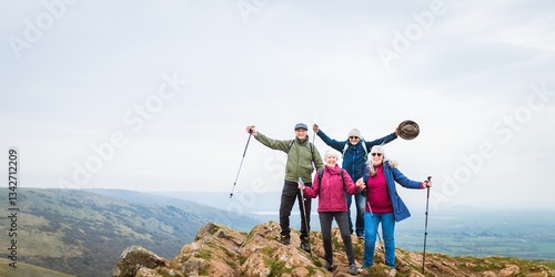 Φωτογραφία Group of four people hiking on a rocky hilltop, enjoying nature