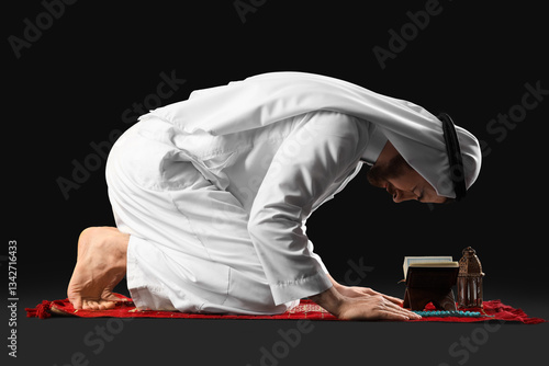 Young Muslim man with Koran...