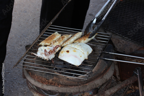 Grilled squid on a charcoal stove