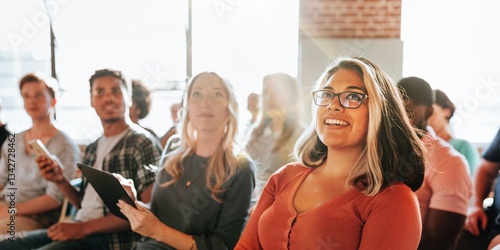 Fotografie Diverse group of people, including a smiling woman, attending seminar