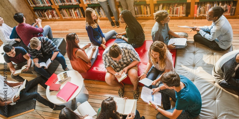 Diverse group of students studying in a library. Students reading, discussing, and collaborating. Cozy library setting with books and comfortable seating. High school students reading in library.